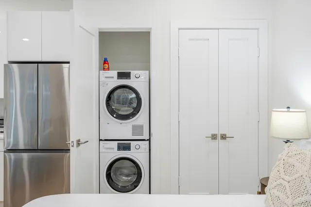 a view of a bedroom with washer and dryer