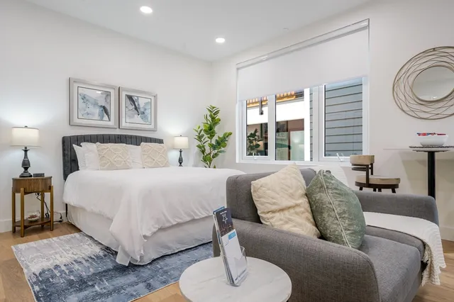 a bedroom with a large bed and a couch