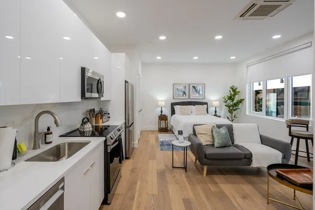 a bedroom with a bed a couch and dresser