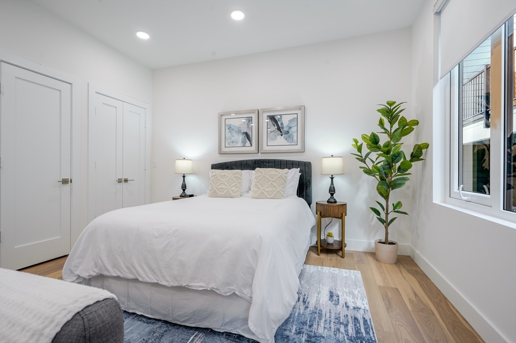 38 Hichborn Street, Unit 404FURNISHE Boston, MA 02135 - Photo 10 of 16 a bedroom with a large bed and a potted plant