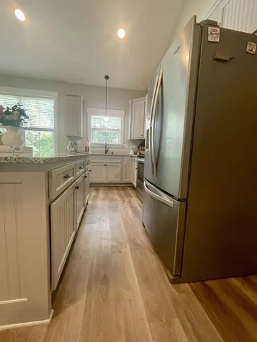 a kitchen with stainless steel appliances a refrigerator sink and cabinets