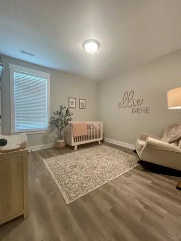 a bedroom with furniture and a flat screen tv
