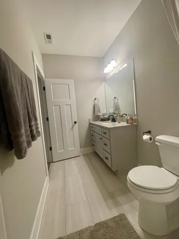 a bathroom with a sink toilet and mirror