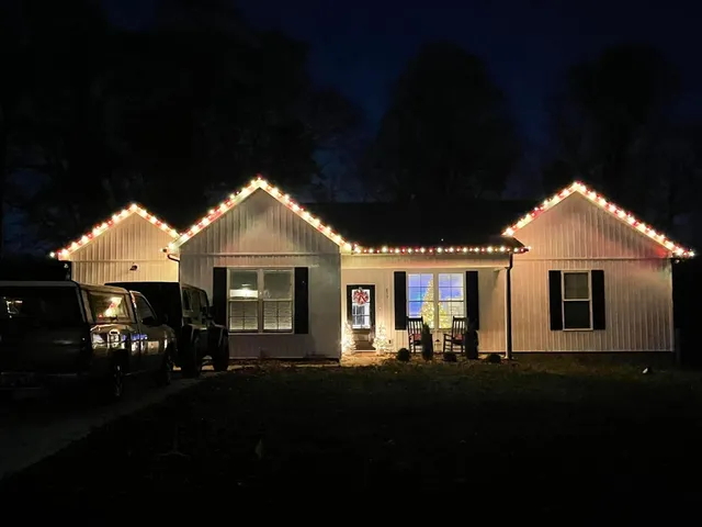 a front view of a house with a yard outdoor seating and mountain view