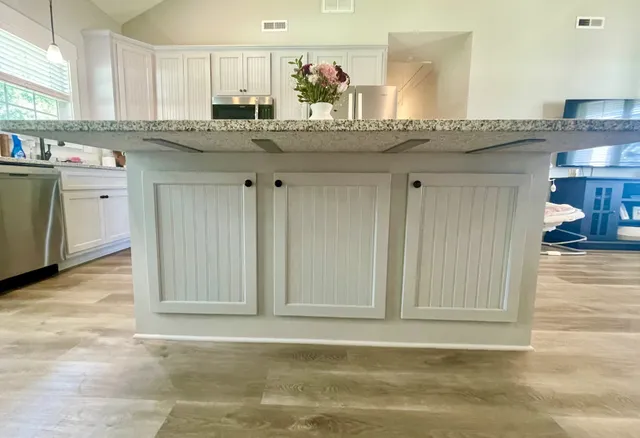 a kitchen with stainless steel appliances granite countertop a sink and cabinets