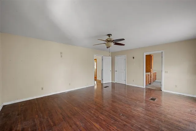 a view of an empty room and wooden floor