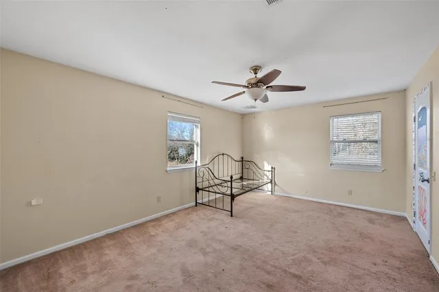 a view of a livingroom with a ceiling fan and window