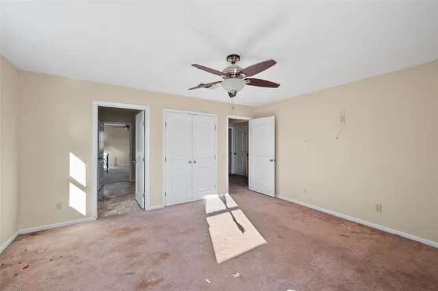 a view of a livingroom with a ceiling fan and window