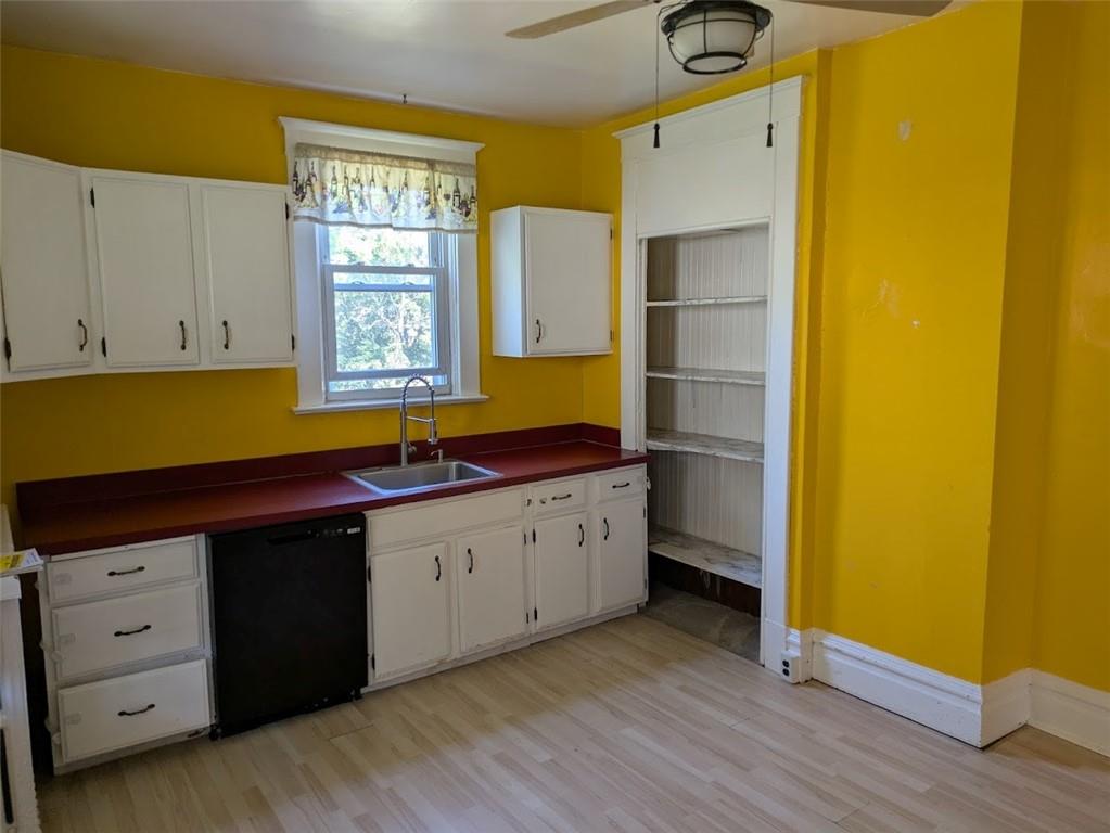 413 North 3rd Street Jeannette, PA 15644 - Photo 12 of 38 a kitchen with white cabinets and wooden floors