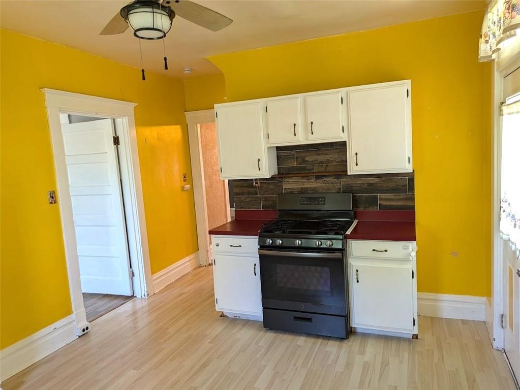 413 North 3rd Street Jeannette, PA 15644 - Photo 13 of 38 a kitchen with a stove and a refrigerator