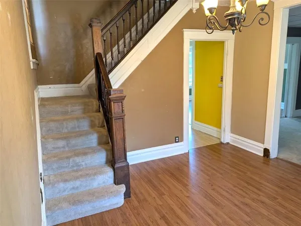 a view of entryway with wooden floor and stairs
