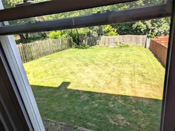 a view of a house with a yard and a garden