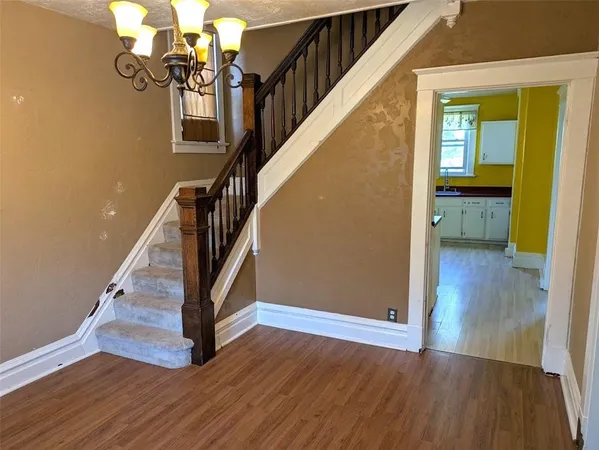 a view of entryway and hall with wooden floor