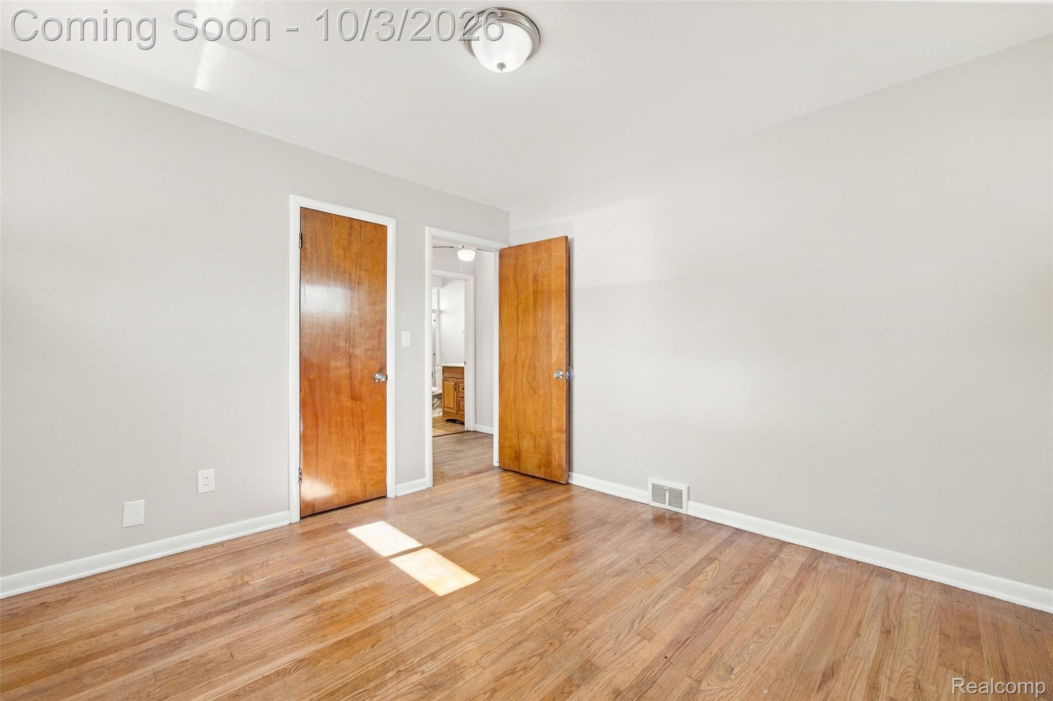 556 Henry Ruff Road Garden City, MI 48135 - Photo 18 of 49 Hardwood-finish flooring, light-toned wall paint, and a ceiling-mounted light fixture