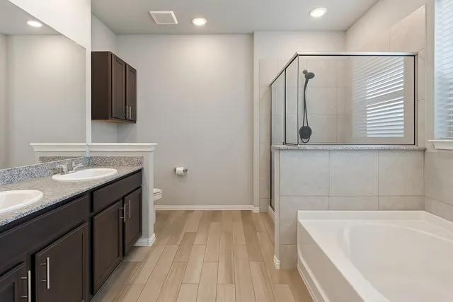a bathroom with a tub sink and mirror