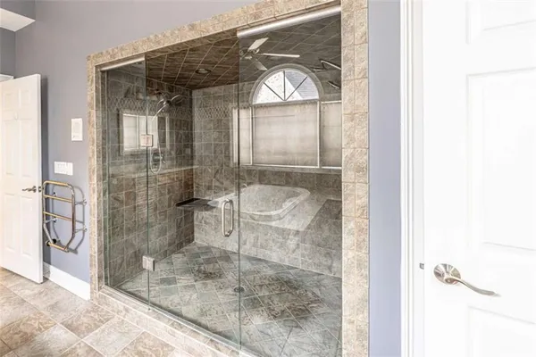a bathroom with a glass shower door and a sink