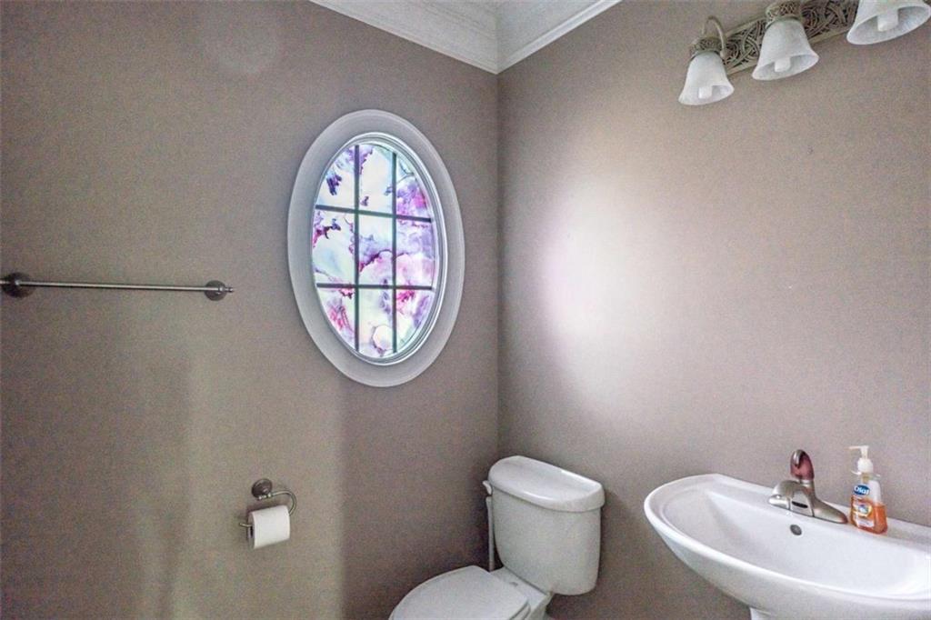 4 Bridgeview Drive Southeast Rome, GA 30161 - Photo 34 of 42 a bathroom with a toilet a sink and a mirror