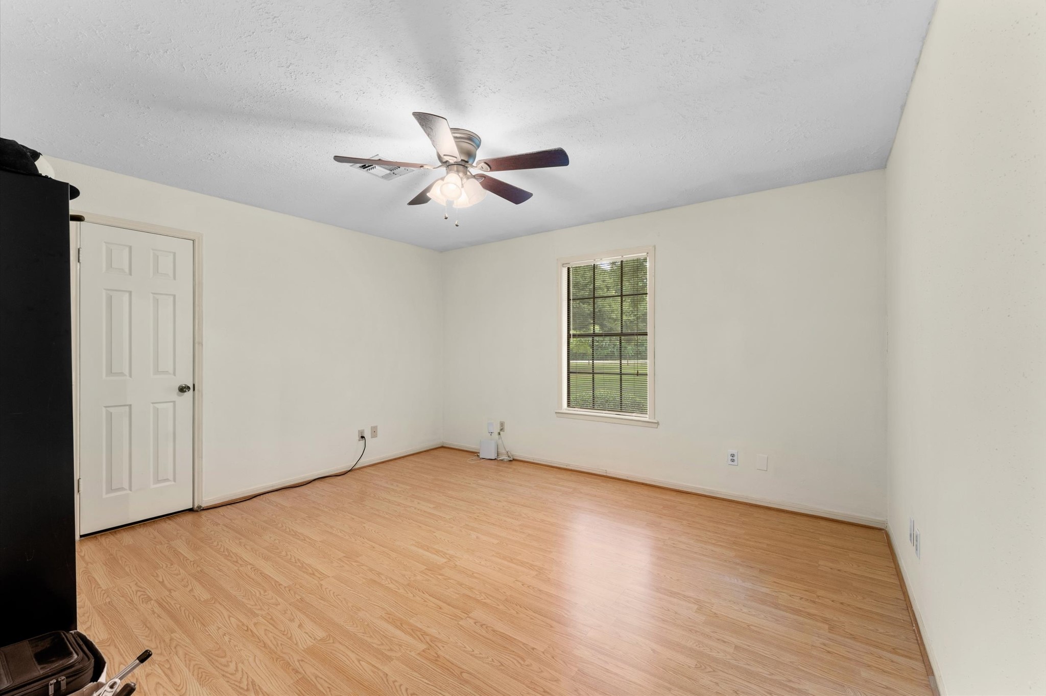 22634 Park Road Tomball, TX 77377 - Photo 21 of 29 Spacious room with neutral walls, and a ceiling fan, offering abundant natural light through a large window.