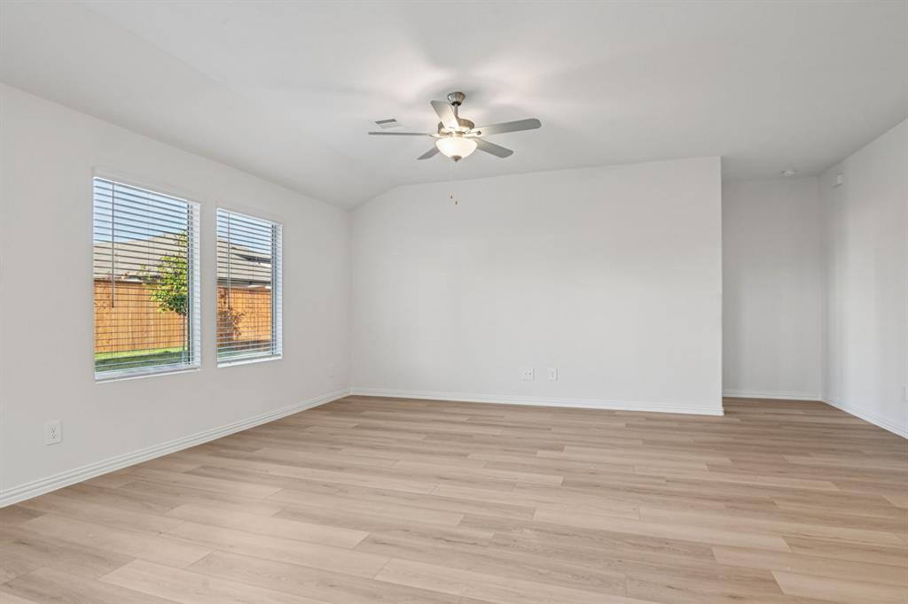2203 Rannoch Street Sherman, TX 75092 - Photo 12 of 37 a view of empty room with wooden floor and fan