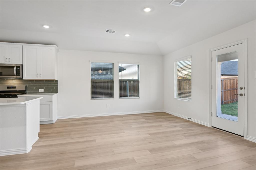 2203 Rannoch Street Sherman, TX 75092 - Photo 15 of 37 a view of kitchen with wooden floor electronic appliances and window