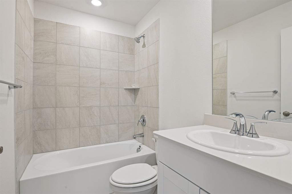 2203 Rannoch Street Sherman, TX 75092 - Photo 27 of 37 a bathroom with a bathtub shower sink vanity and toilet