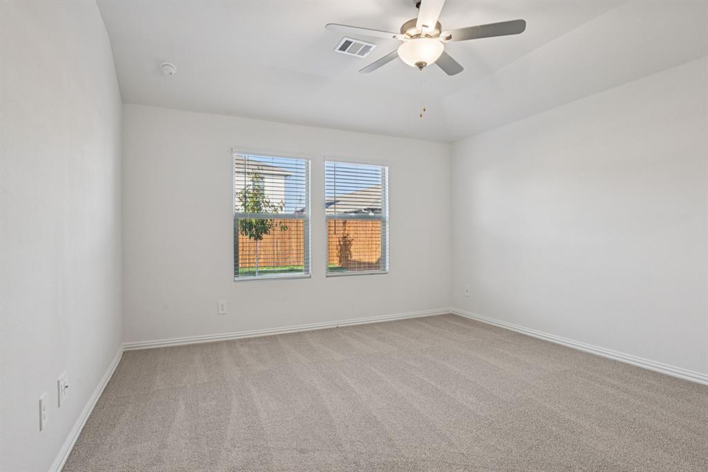 2203 Rannoch Street Sherman, TX 75092 - Photo 30 of 37 an empty room with windows and fan