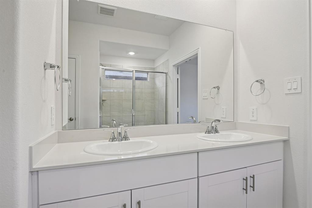 2203 Rannoch Street Sherman, TX 75092 - Photo 33 of 37 a bathroom with double sink and a mirror