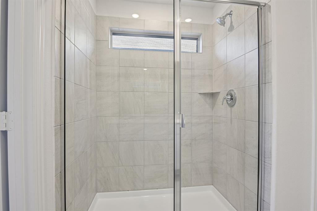 2203 Rannoch Street Sherman, TX 75092 - Photo 34 of 37 a bathroom with a glass shower door