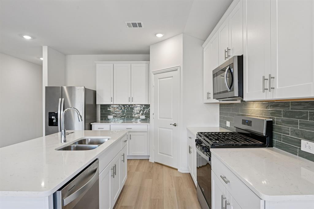 2203 Rannoch Street Sherman, TX 75092 - Photo 5 of 37 a kitchen that has a sink and a stove in it
