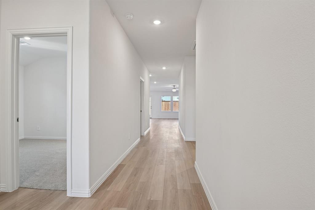 2203 Rannoch Street Sherman, TX 75092 - Photo 9 of 37 a view of a hallway with wooden floor