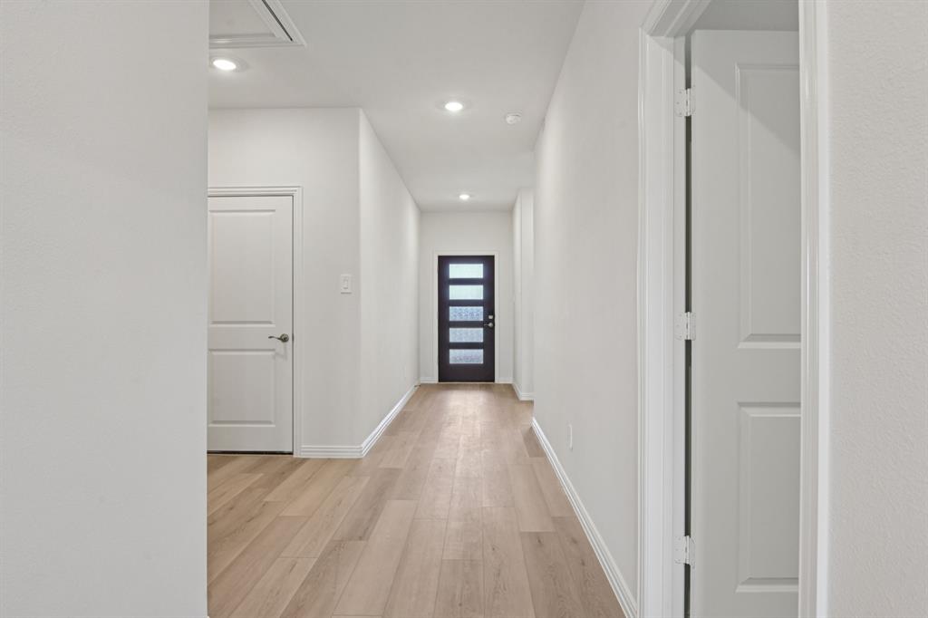 2203 Rannoch Street Sherman, TX 75092 - Photo 10 of 37 a view of a hallway with wooden floor and staircase