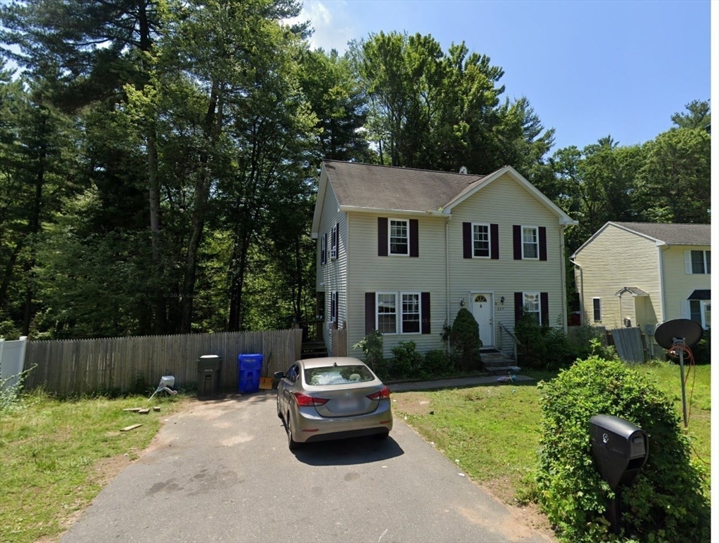 a car parked in front of a white house