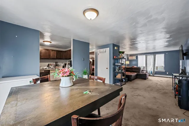 a kitchen with sink a refrigerator and chairs
