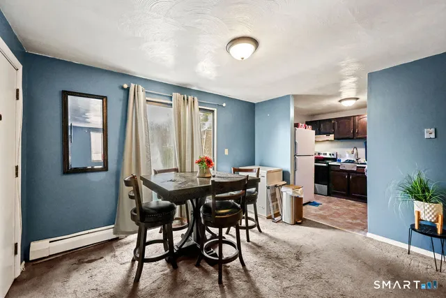 a view of a dining room with furniture and window