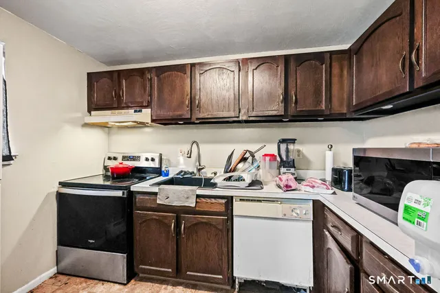 a kitchen with stainless steel appliances granite countertop a sink stove and cabinets