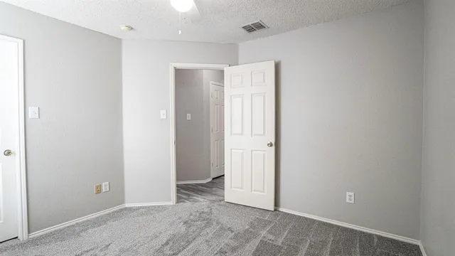 a view of backyard with wooden fence and trees