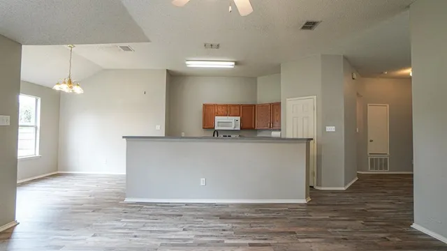 a kitchen with stainless steel appliances granite countertop a sink stove and cabinets