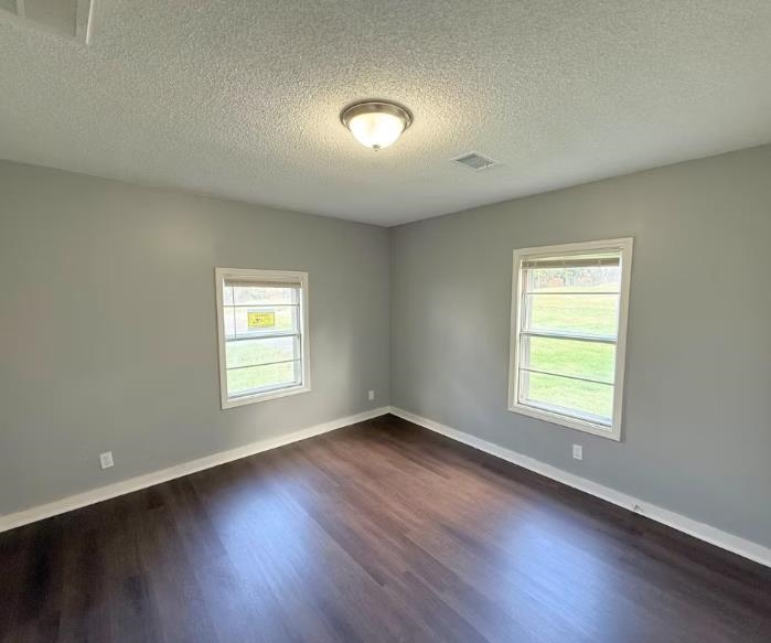 433 Dixie Road Memphis, TN 38109 - Photo 5 of 11 an empty room with wooden floor and windows