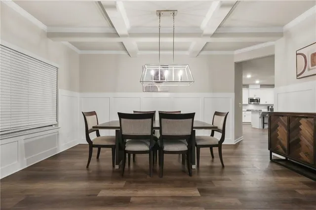 a view of a dining room with furniture a chandelier and wooden floor