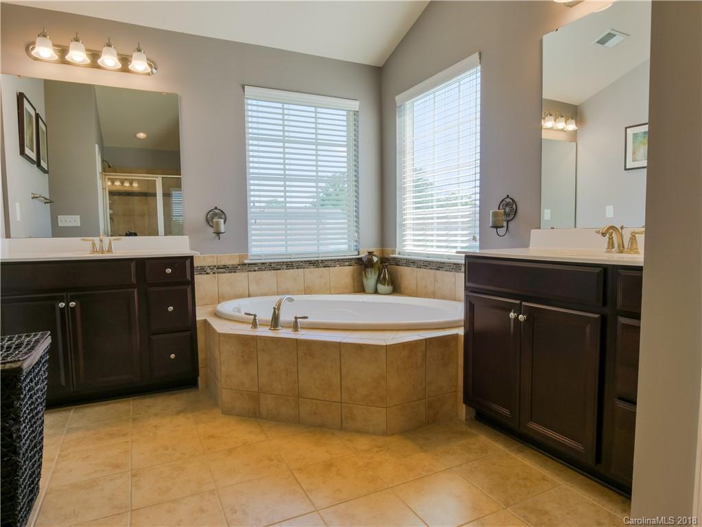1621 Ridgehaven Road Waxhaw, NC 28173 - Photo 21 of 36 a spacious bathroom with a tub sink and mirror