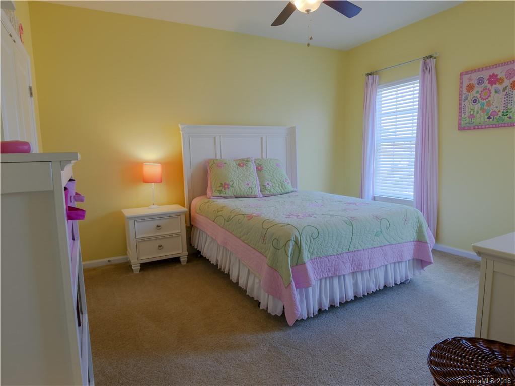 1621 Ridgehaven Road Waxhaw, NC 28173 - Photo 22 of 36 a bedroom with a bed and a chandelier