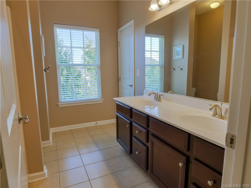 1621 Ridgehaven Road Waxhaw, NC 28173 - Photo 26 of 36 a bathroom with a sink a mirror and a bathtub