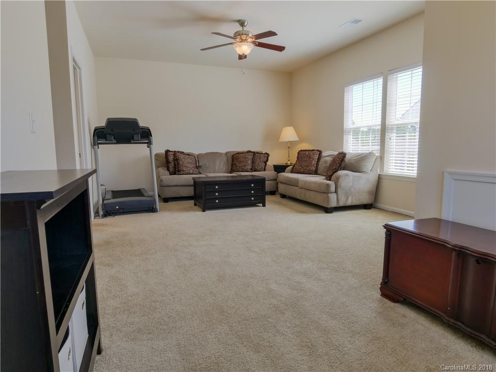 1621 Ridgehaven Road Waxhaw, NC 28173 - Photo 27 of 36 a living room with furniture and a fireplace