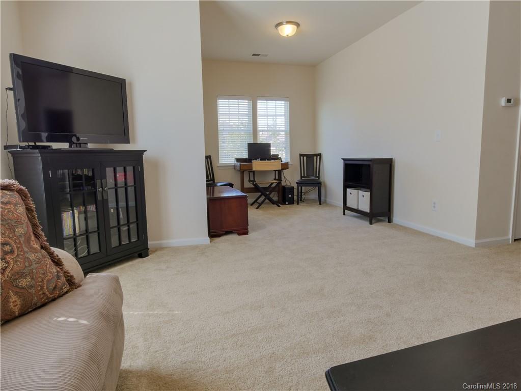 1621 Ridgehaven Road Waxhaw, NC 28173 - Photo 28 of 36 a living room with furniture and a flat screen tv