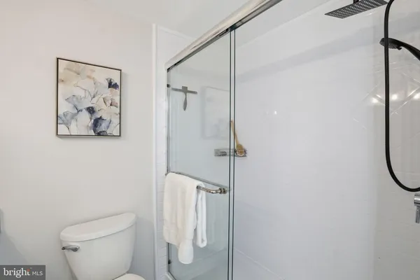 a bathroom with a toilet and a shower