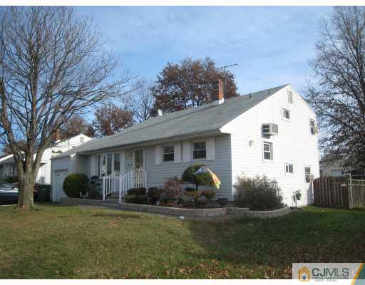 52 Eardley Road Edison, NJ 08817 - Photo 1 of 10 a view of a white house in front of a yard with potted plants and large trees