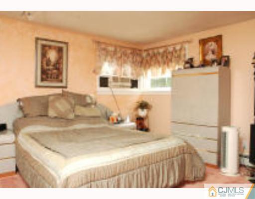 52 Eardley Road Edison, NJ 08817 - Photo 5 of 10 a bedroom with a bed and a couch