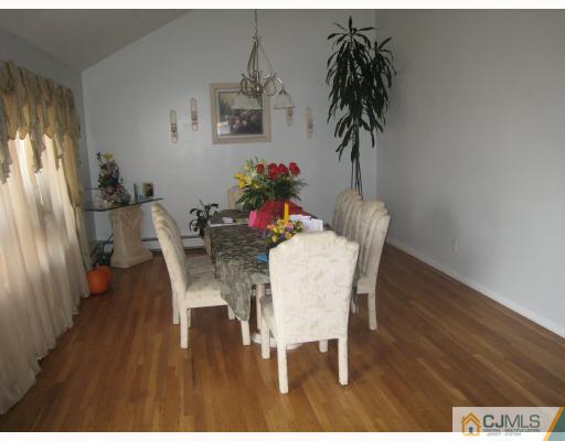 52 Eardley Road Edison, NJ 08817 - Photo 6 of 10 a dining room with furniture potted plants and wooden floor