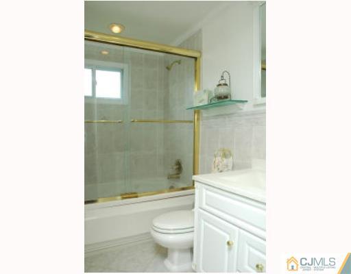 52 Eardley Road Edison, NJ 08817 - Photo 8 of 10 a bathroom with a sink a toilet and shower