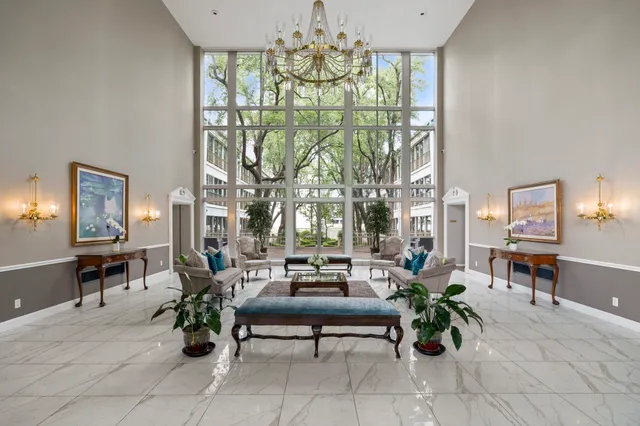 a living room with furniture and a chandelier